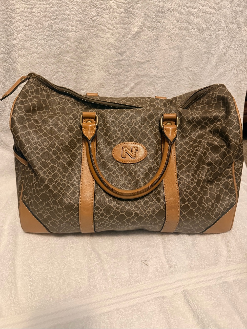 Nina Ricci Brown Patterned Duffel with Tan Trim. Has lock and key.